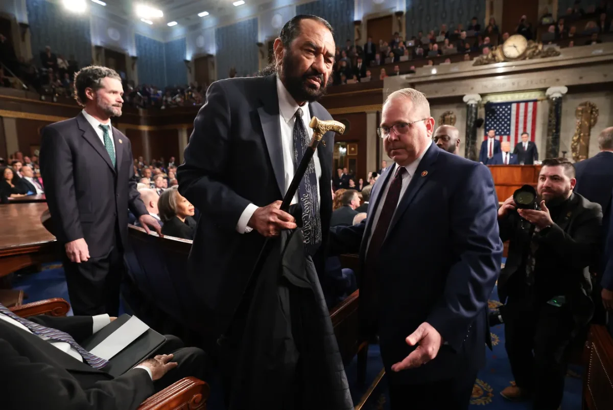 Rep. Green being escorted out of the House Chamber.