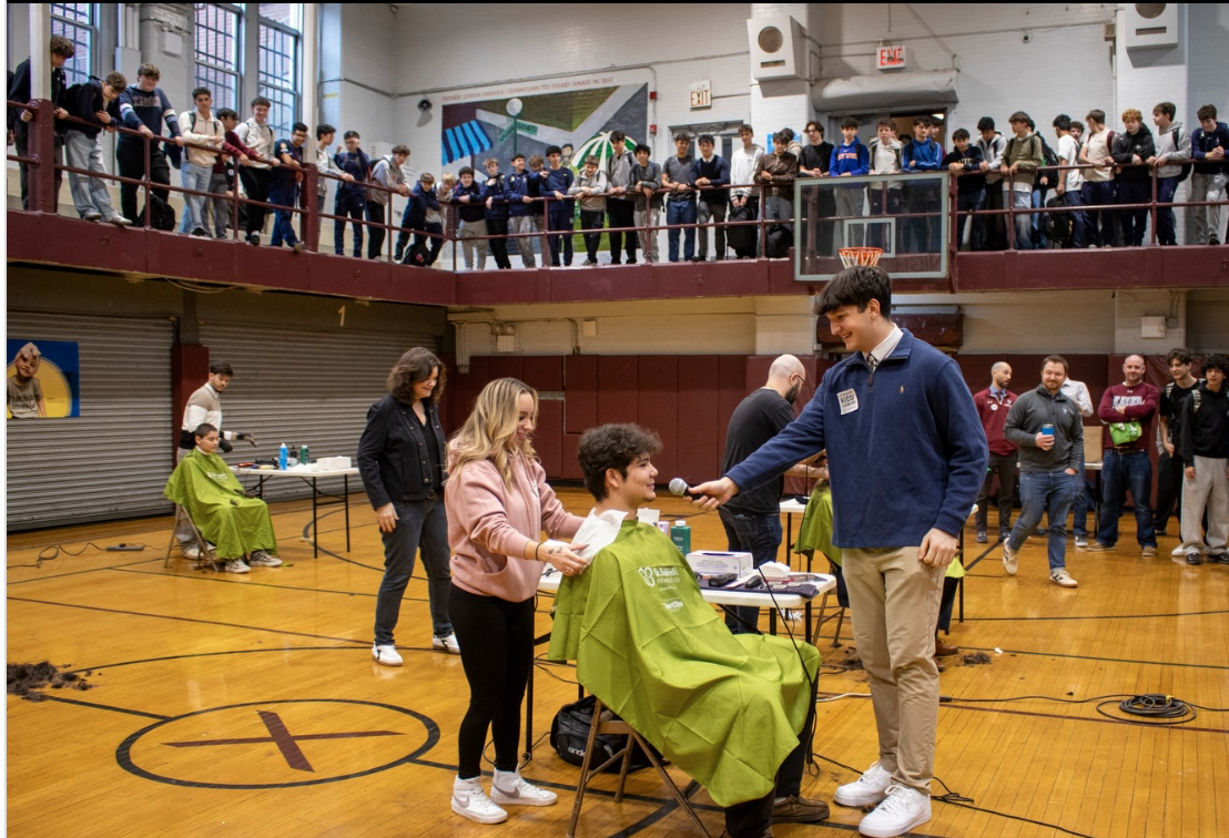 Student Body President Dom Cognata '26 (right) is interviewing Paul Esposito '26 (left) before he gets his head shaved. 
