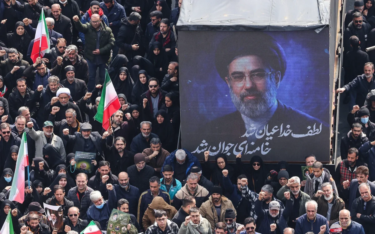 A screen displays a portrait of Iran's new supreme leader Mojtaba Khamenei during the funerals of Islamic Revolutionary Guards Corps commanders, army commanders and others killed in the early days of the US and Israeli strikes on Iran, at Enghelab Square in Tehran on March 11, 2026. 